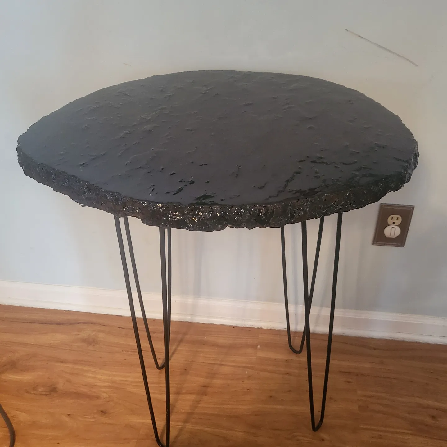 Shadows concrete table with dark tones and metal base